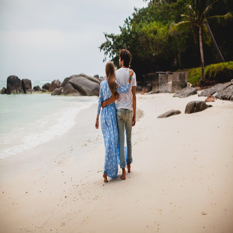 young stylish hipster couple in love on tropical beach during vacation honey moon, embrace, lovely, romance, tenderness, blue dress